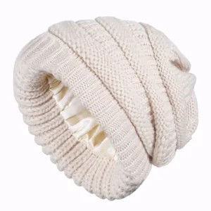 Beige knitted slouchy beanie with smooth satin lining for women, windproof warm winter hat.