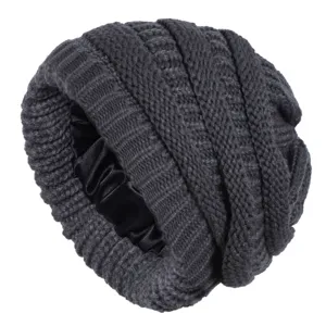Dark grey knit beanie detail shot, featuring a smooth black satin lining and warm fabric.