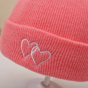 Cute baby knit hat with double heart embroidery, warm and comfortable winter cap for infants.