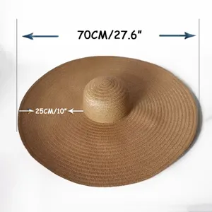 Oversized straw sun hat for women with 70cm wide brim, ideal for beach vacation and sun protection.