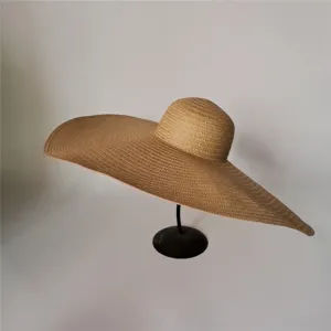 Detail view of the 70cm oversized straw hat, foldable beach sun hat for women vacation use.