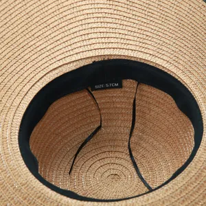 Detailed view of the women straw sun hat inner brim showing size tag and woven texture.