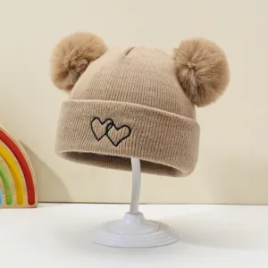 Cute baby knitted beanie hat featuring double pom poms and sweet heart embroidery.