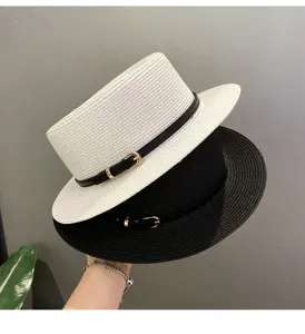 Detailed shot of stylish flat top straw hats in black and white with chic belt decoration.