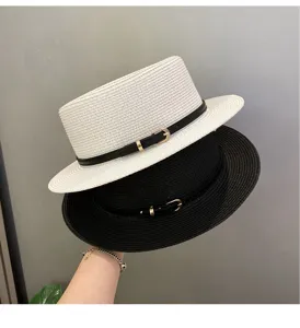 Detailed close-up of the stylish straw fedora hat, showing the black belt and metal buckle.
