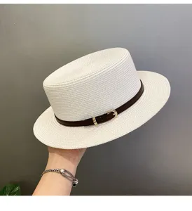 Stylish white flat top straw hat with brown belt detail, perfect for summer beach and vacation.