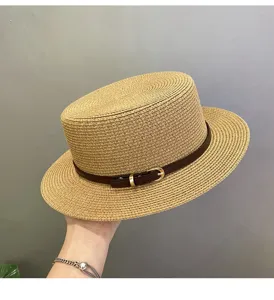 Summer straw boater hat with brown leather belt and metal buckle for beach vacation