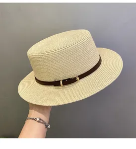 Detail view of summer straw fedora hat featuring a chic brown decorative belt buckle.