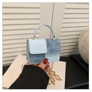 Chic patchwork mini top handle bag with denim and PU leather, stylish chain shoulder strap.