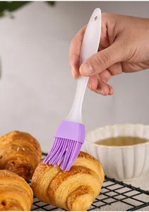 Small silicone pastry brush for baking and BBQ, flexible bristles with hanging hole for kitchen.