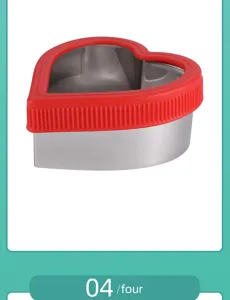 Stainless steel heart sandwich cutter baking mold with red silicone hand guard for cookies.