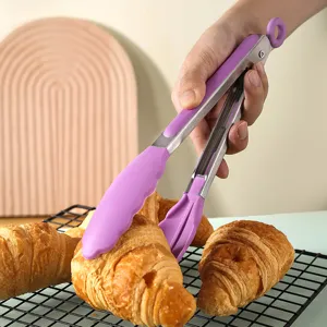 Stainless steel food tongs with purple silicone tips, perfect for cooking, grilling, and baking use.