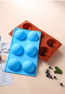 Silicone half sphere baking mold detail view showing flexible blue and brown 6-hole chocolate tray