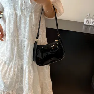 Classic black patent leather underarm shoulder bag for women, chic minimalist hobo handbag style.
