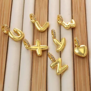Close-up detail of gold-plated bubble letter charms, perfect for DIY jewelry making pendants