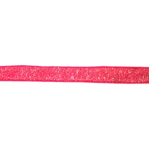 Close up detail shot of bright pink glitter velvet ribbon texture, shiny crafting material.