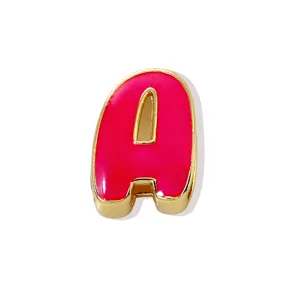 Detailed shot of a gold-plated letter A pendant with vibrant pink enamel finish, cute style.