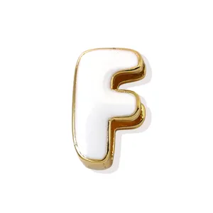 Close-up detail shot showcasing the golden edge and white enamel of letter F pendant.