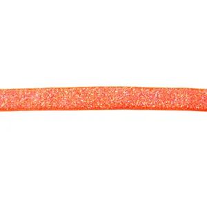 Detailed close-up of shiny orange glitter velvet ribbon, perfect for DIY hair bows and crafts.
