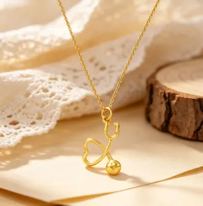 Delicate gold heart stethoscope pendant necklace, elegant and fashionable daily jewelry accessory.