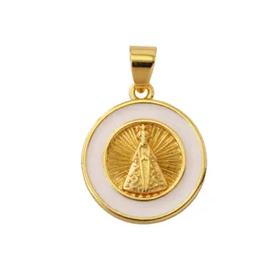 Close-up detail of the gold-plated religious pendant with white enamel and embossed figure.