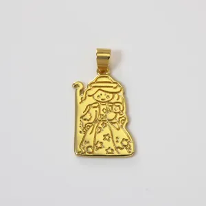 Golden brass pendant charm featuring engraved traditional figure and star patterns detail shot.