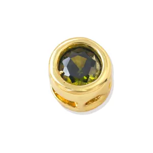 Gold plated DIY charm bead with green zircon gemstone, close-up detail shot for jewelry making.