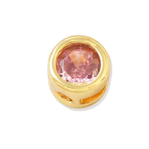 Close-up of the gold-plated DIY charm bead featuring a sparkling pink cubic zirconia stone.