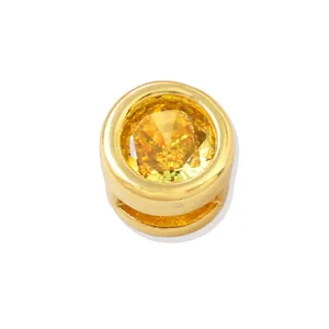 Detail shot of round yellow zirconia gemstone bead set in gold plated metal, ideal for DIY jewelry.