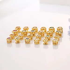 Detail view of 18k gold plated copper charm beads with colorful cubic zirconia for DIY jewelry.