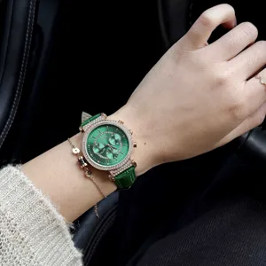 Close-up view of Scottie diamond watch with a green leather strap on model wrist