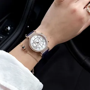 Close-up of Scottie quartz watch with diamond bezel and blue leather strap on wrist