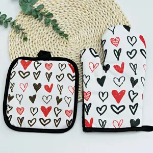 Detailed view of heat-resistant kitchen glove and pot holder set with heart pattern