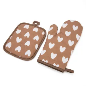 Brown heat-resistant oven mitt and pot holder set with white heart pattern for baking