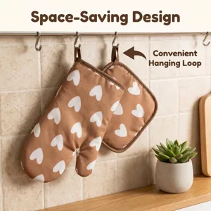 Detail view of brown oven mitts with heart print featuring a convenient hanging loop