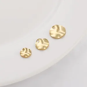 Detailed view of three 14K gold plated brass wavy disc charms for DIY jewelry making