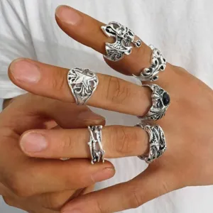 Close-up detail of gothic punk vintage rings set showing stacked style on fingers