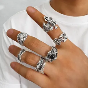 Vintage gothic punk skull rings set worn on hand for Halloween jewelry detail view