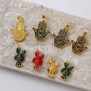 Brass 18K gold plated enamel Hamsa hand and lobster charms detail view, DIY jewelry making accessory.