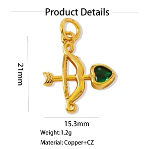 Close-up detail of gold-plated copper bow and arrow pendant with green cubic zirconia stone.