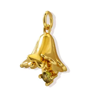 Detail close-up of exquisite gold flower pendant with green cubic zirconia gemstone jewelry accessory.