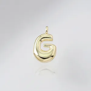 Close-up detail shot of the cute chunky bubble letter G gold pendant with glossy finish.