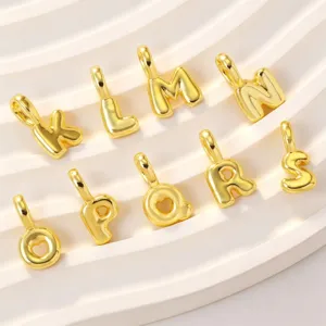 Close-up detail of gold puffy letter pendants showcasing metallic finish and pendant bail design.