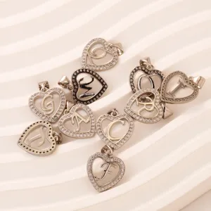 Silver tone heart alphabet letter pendant paved with crystal stones for DIY jewelry making.