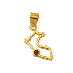 Gold map pendant detail close up showing red gemstone inset, elegant DIY jewelry accessory.