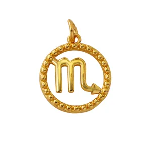 Detailed shot of gold-plated Scorpio zodiac pendant with beaded round frame design.