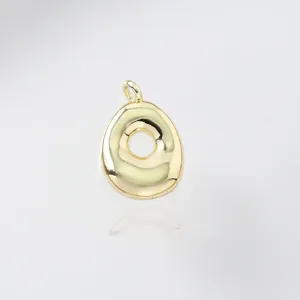 Golden puffy letter pendant close-up, minimalist jewelry detail shot, glossy metallic finish.