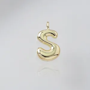 Gold puffy letter S pendant detail view, sleek metallic finish close-up view accessory piece.