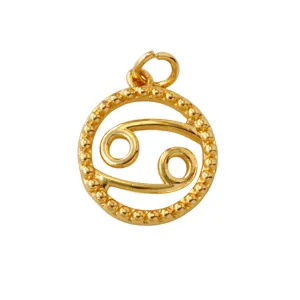 Detailed close-up of a gold-plated brass Cancer zodiac pendant with delicate beaded ring.