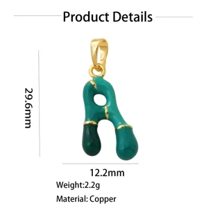 Gold-plated copper letter pendant detail showing green enamel finish, 29.6mm height.